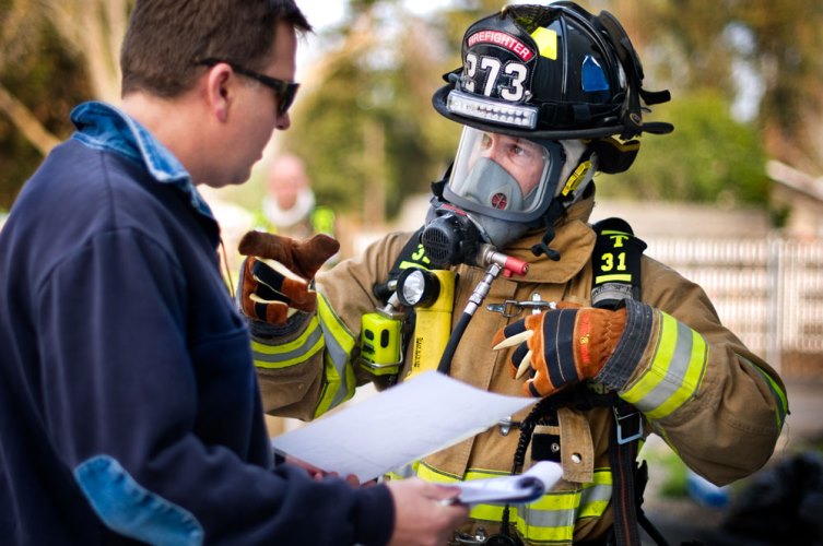 Firefighter talking with another man